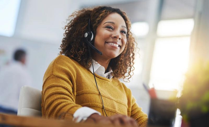 African woman, call center agent or smile with voip for consulting, listening or contact us in office. Female consultant, customer service or tech support crm with headphones, microphone or help desk.
