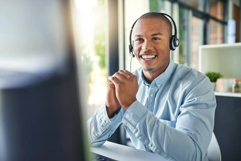Call center, customer service and happy black man on computer for consulting, help and advice. Telemarketing, communication and male consultant smile for contact, crm support and networking in office.