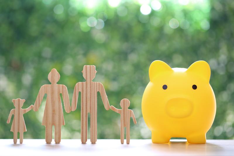 Model family with piggy bank on natural green background,Save money for prepare in future and family finance concept