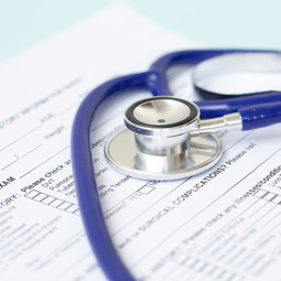 Stethoscope and patient medical history form. Health check diagnostics concept. 