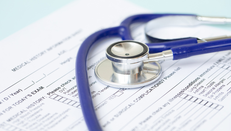 Stethoscope and patient medical history form. Health check diagnostics concept. 