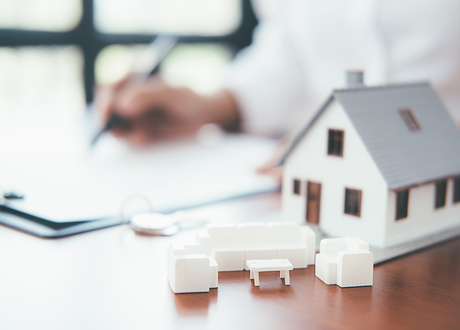 House model with real estate agent and customer discussing for contract to buy house, insurance or loan real estate background.