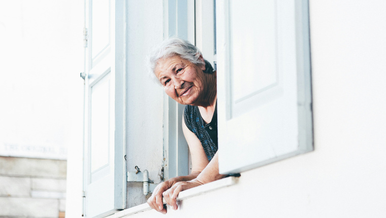 Elderly Woman Leaning Out of Window