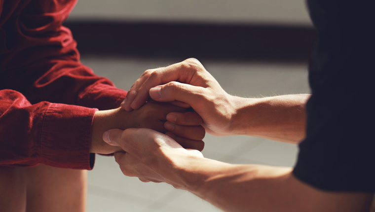 Man holding a woman's hand for warm, as psychological counseling concept of support, understanding care in love, Concept about encouraging and fighting problems.
